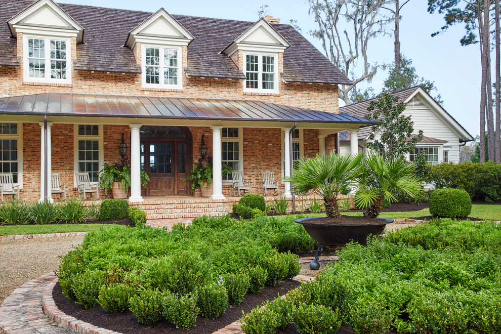 Inspiration for a coastal full sun front yard brick landscaping in Other.