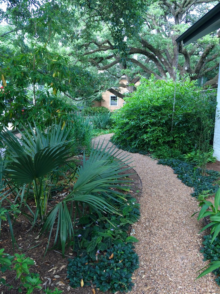 Design ideas for a large bohemian back full sun garden in Houston with a garden path and brick paving.