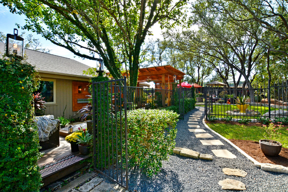 Photo of a large contemporary full sun backyard gravel walkway in Austin.
