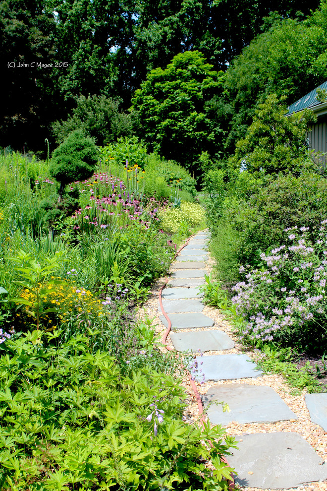 Esempio di un grande giardino xeriscape country esposto in pieno sole davanti casa in estate con pavimentazioni in pietra naturale