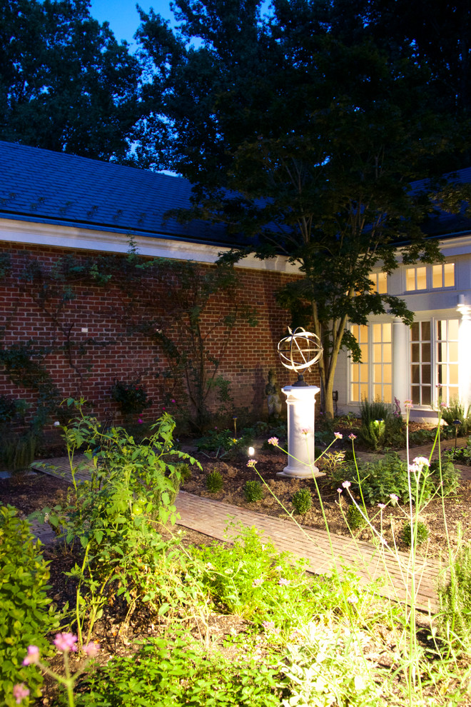 This is an example of a mid-sized traditional partial sun courtyard brick formal garden in DC Metro for summer.