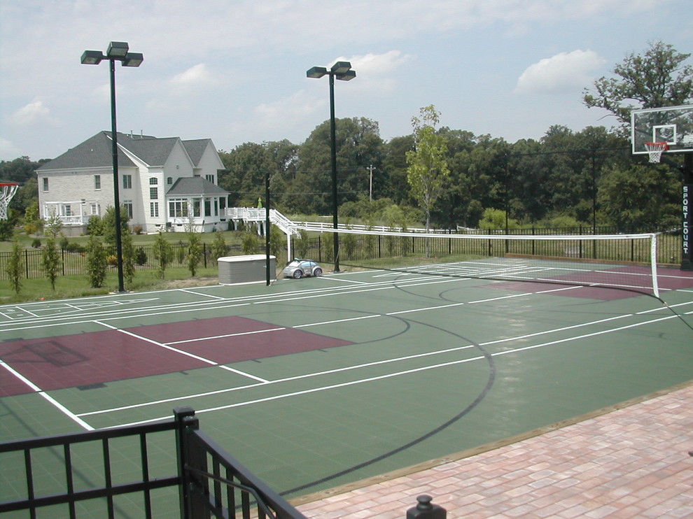 Photo of an expansive contemporary back partial sun garden for summer in DC Metro with an outdoor sport court and brick paving.