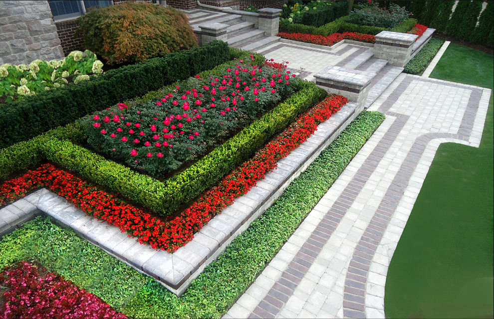 Esempio di un grande giardino formale minimal esposto a mezz'ombra davanti casa in estate con un muro di contenimento e pavimentazioni in mattoni