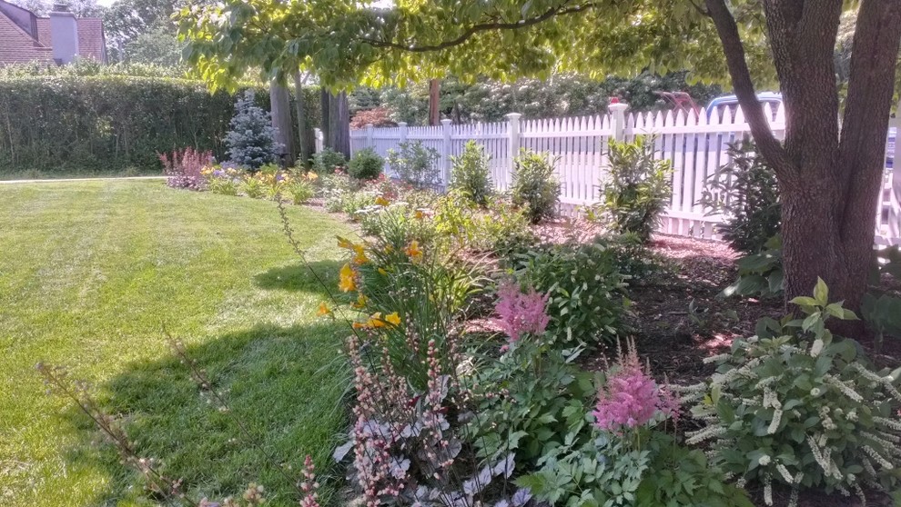 Photo of a large bohemian front partial sun garden in Philadelphia with concrete paving.