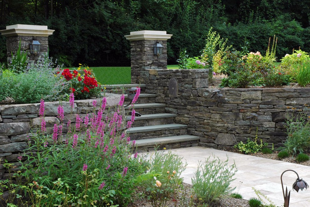 This is an example of a mid-sized traditional full sun hillside concrete paver garden path in New York for spring.