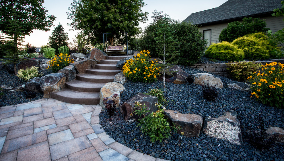 Large rustic back garden in Seattle with a water feature and concrete paving.
