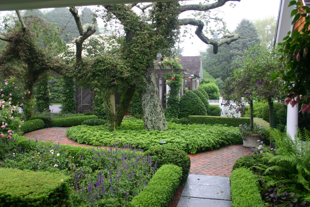 This is an example of a traditional full sun front yard brick landscaping in New York.
