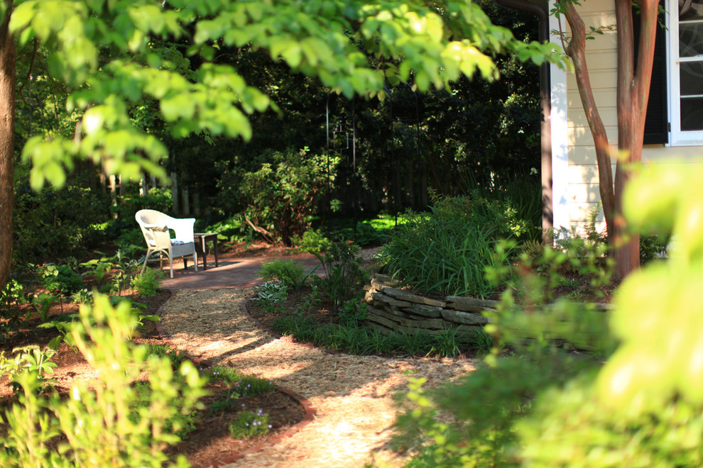 Medium sized shabby-chic style back fully shaded garden for spring in Atlanta with mulch.