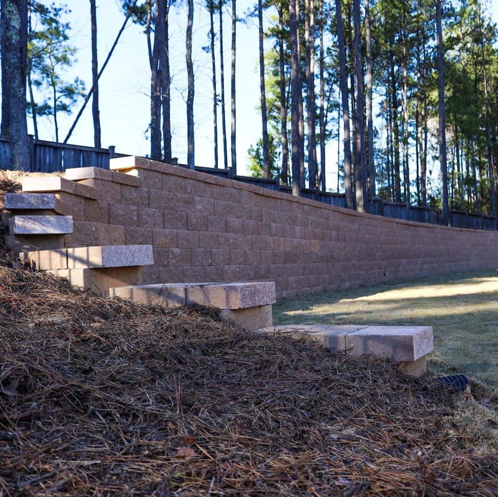 Inspiration for a huge rustic backyard retaining wall landscape in Raleigh.