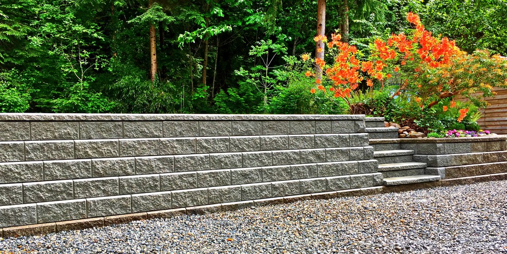 Design ideas for a modern back fully shaded garden wall in Vancouver with a retaining wall and gravel.