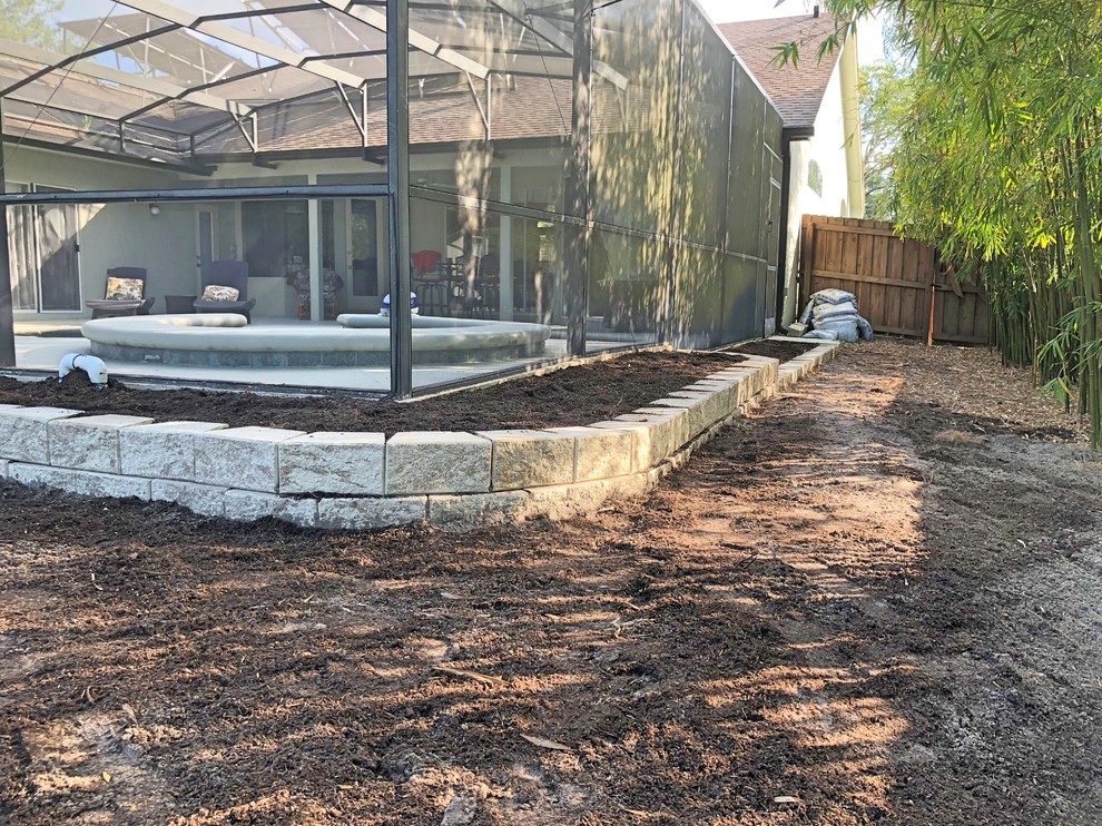 Retaining wall to prevent erosion and create planting beds Landscape
