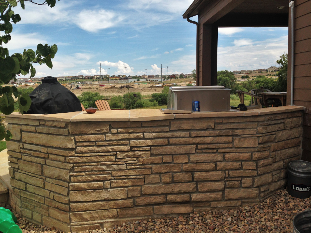 Design ideas for a mid-sized contemporary backyard river rock retaining wall landscape in Denver.
