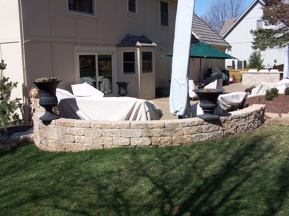 Design ideas for a medium sized classic back partial sun garden in Kansas City with a retaining wall and natural stone paving.