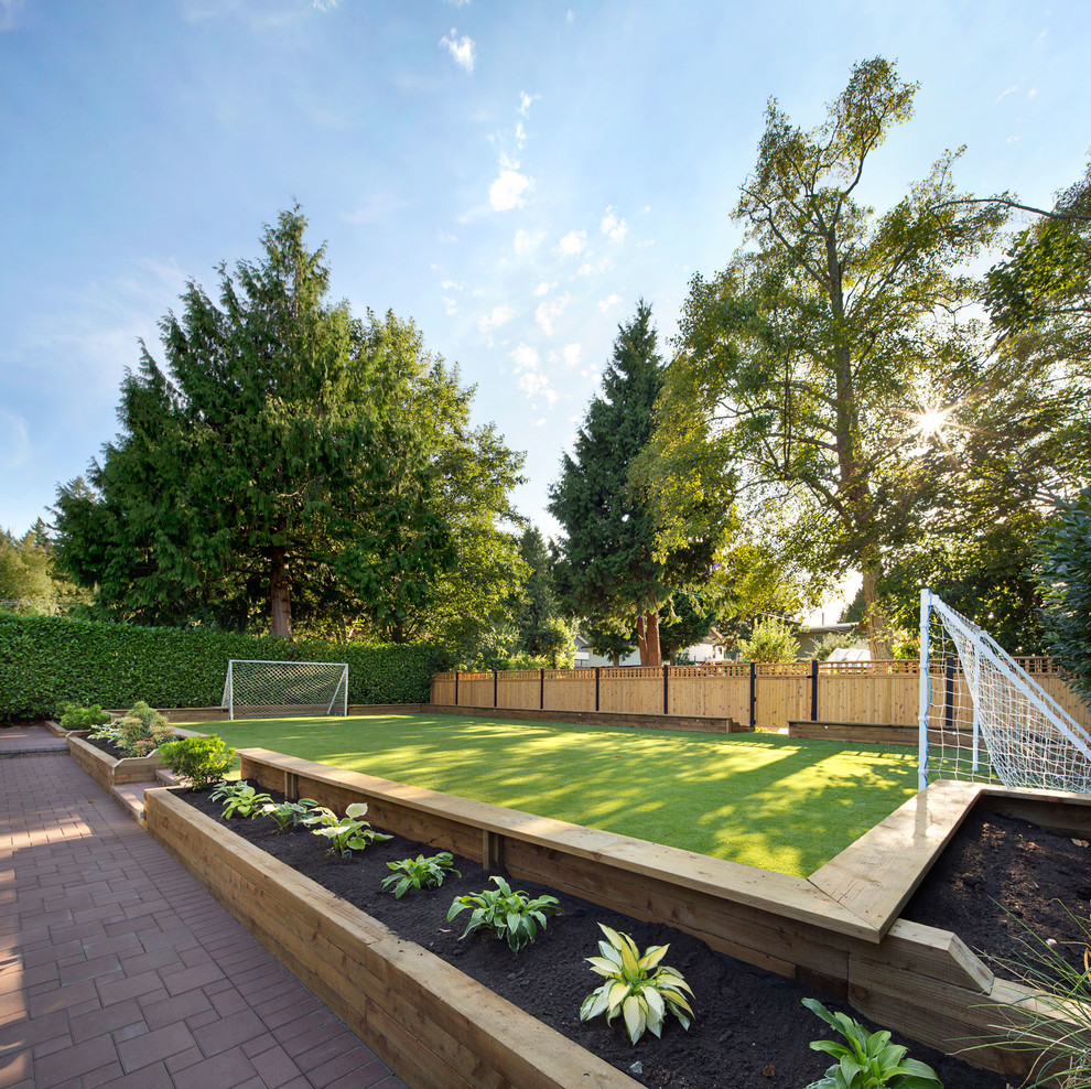 Photo of a contemporary partial sun backyard landscaping in Vancouver.