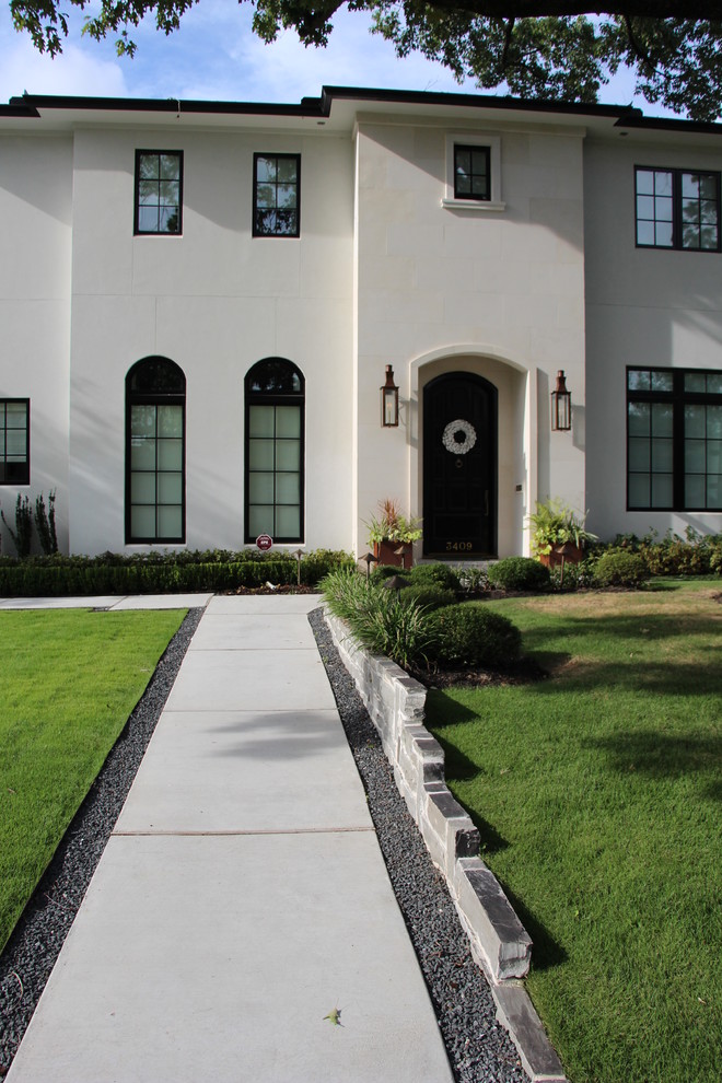 Design ideas for a medium sized contemporary front partial sun garden in Houston with a retaining wall and gravel.