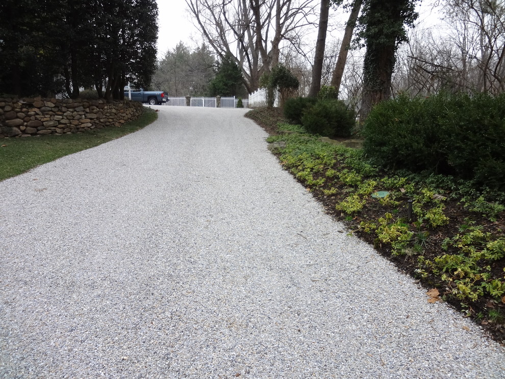 Design ideas for a large traditional full sun front yard gravel driveway in DC Metro for fall.