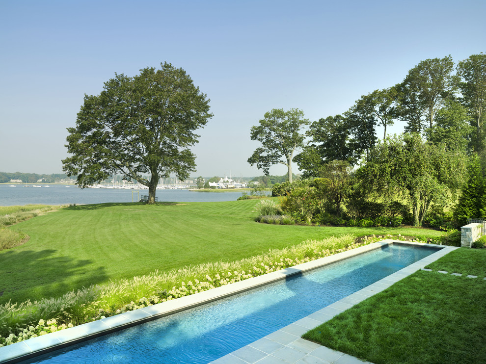 This is an example of an expansive classic back garden in New York.