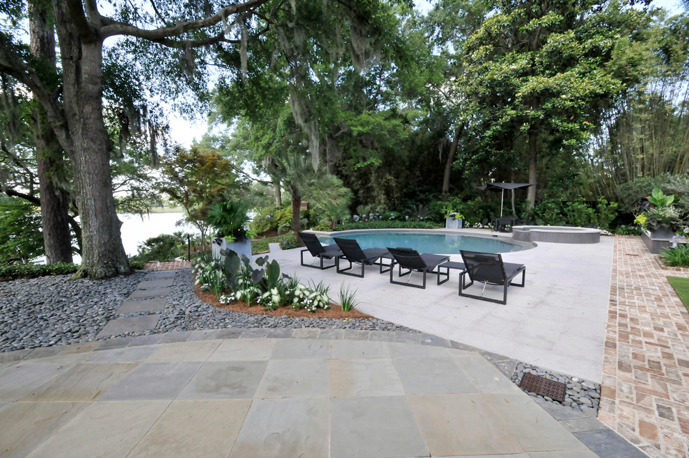 Design ideas for a transitional backyard stone formal garden in Charleston.