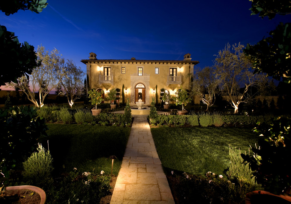 Inspiration for a large mediterranean full sun front yard stone water fountain landscape in Los Angeles.