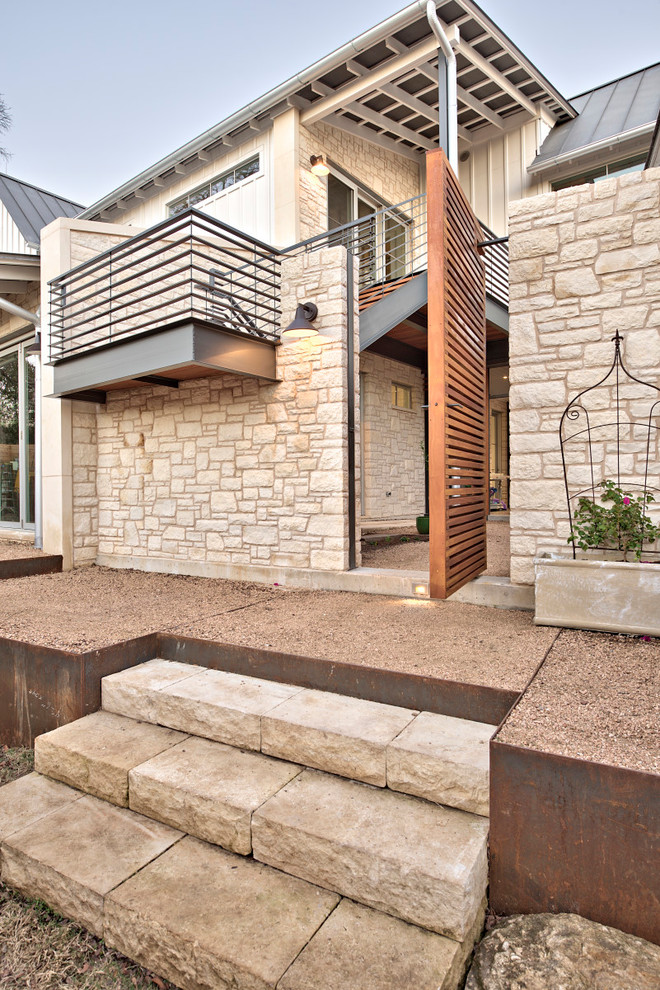 Photo of a large traditional side xeriscape full sun garden in Austin with a garden path and gravel.