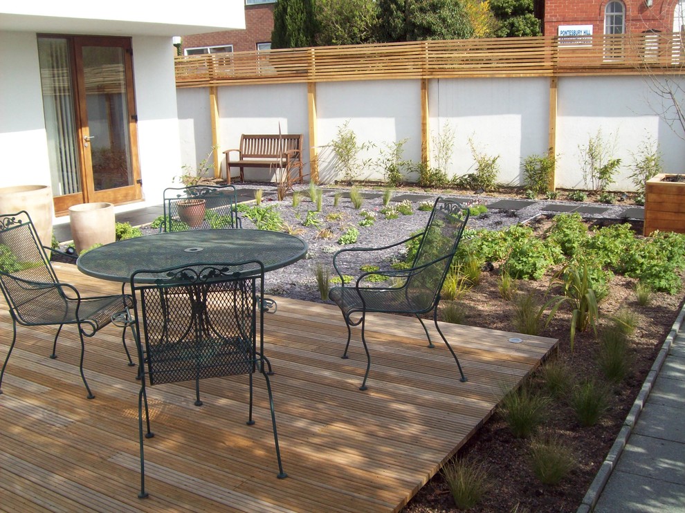 Small classic roof full sun garden in West Midlands with decking.