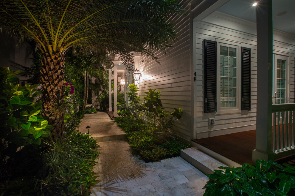 This is an example of a small tropical full sun front yard landscaping in Miami.