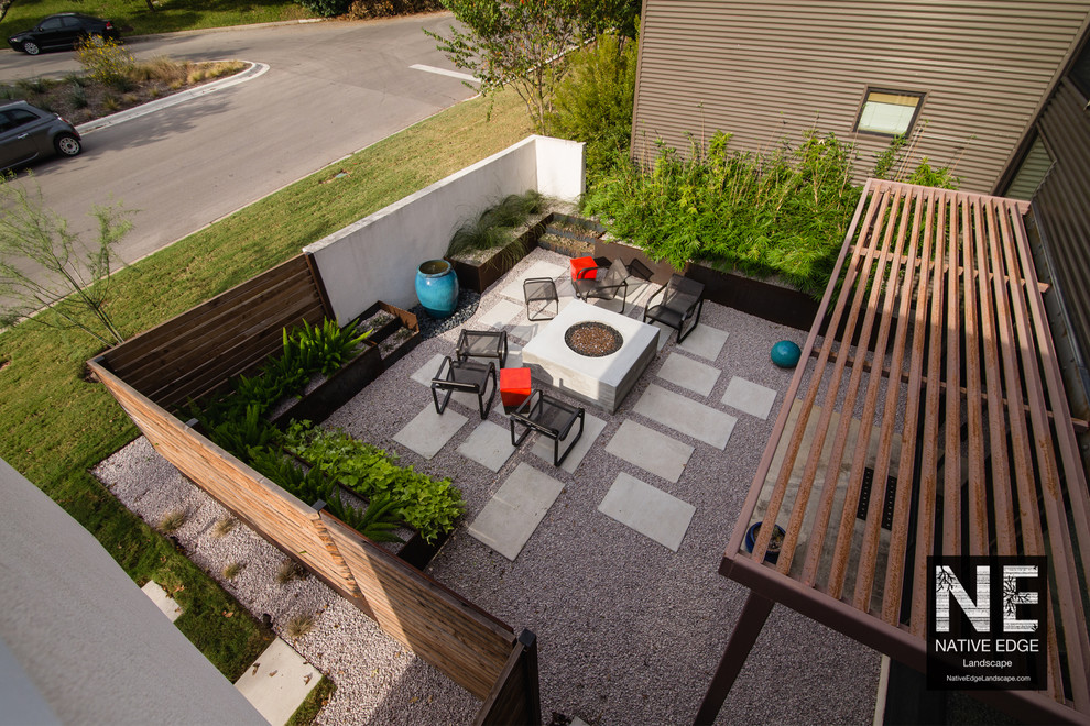 Inspiration pour un petit jardin minimaliste avec des pavés en béton et un foyer extérieur.
