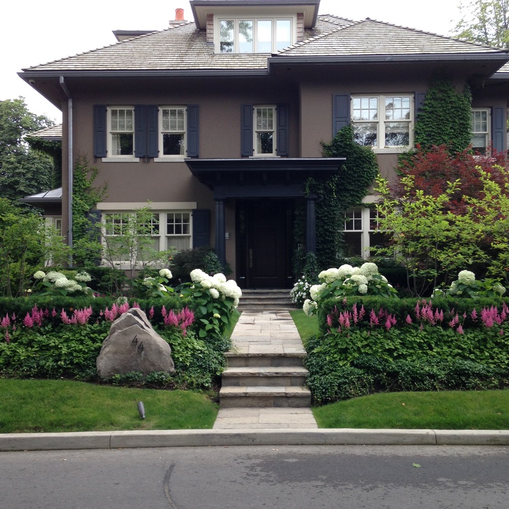 This is an example of a large contemporary front yard concrete paver landscaping in Toronto.