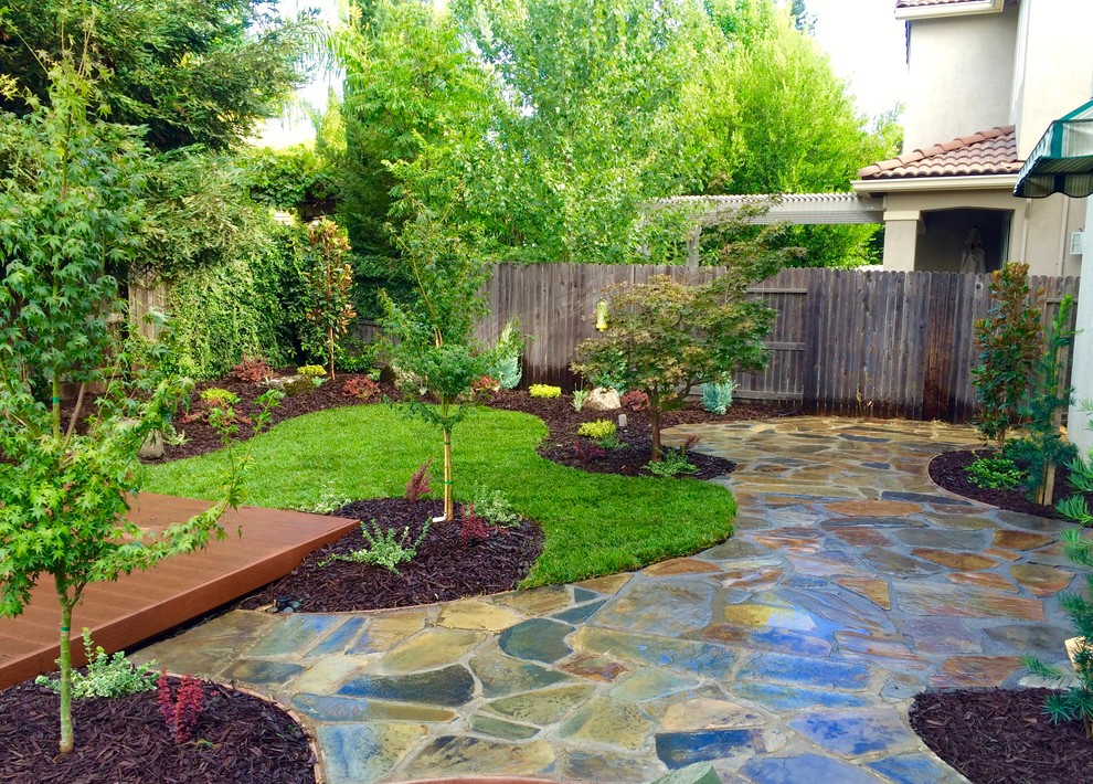 Foto de jardín clásico pequeño en patio trasero con jardín francés, brasero, exposición total al sol y adoquines de hormigón