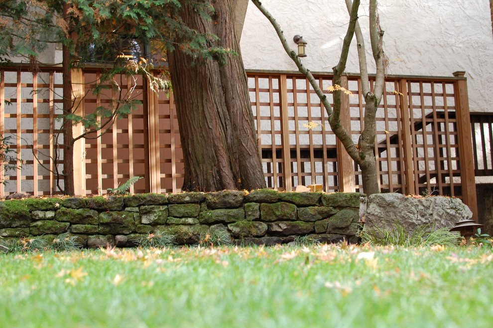 Photo of a small traditional courtyard retaining wall landscape in Portland.
