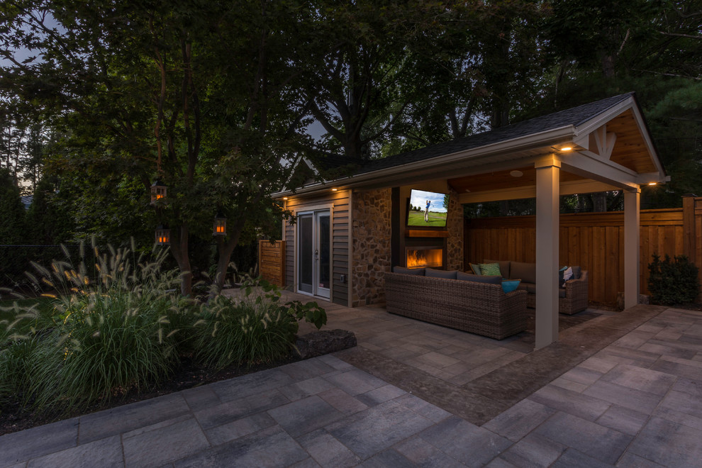 Inspiration for a mid-sized contemporary shade backyard stone landscaping in Toronto for summer.