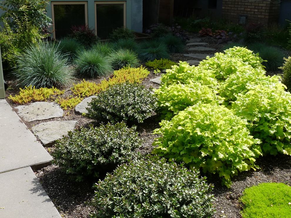 Inspiration for a small transitional partial sun front yard stone landscaping in Portland.