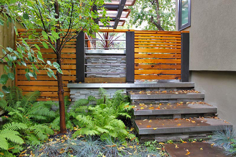 This is an example of a contemporary backyard garden path in Calgary.
