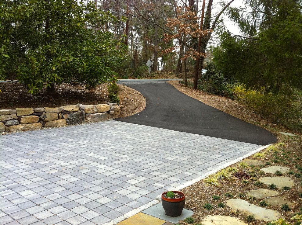 This is an example of a small modern partial sun front yard concrete paver driveway in Richmond for winter.