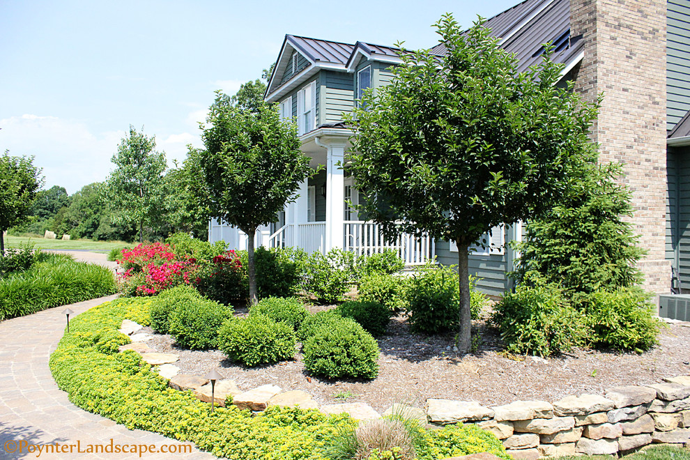 Design ideas for a rural front full sun garden in St Louis with concrete paving.