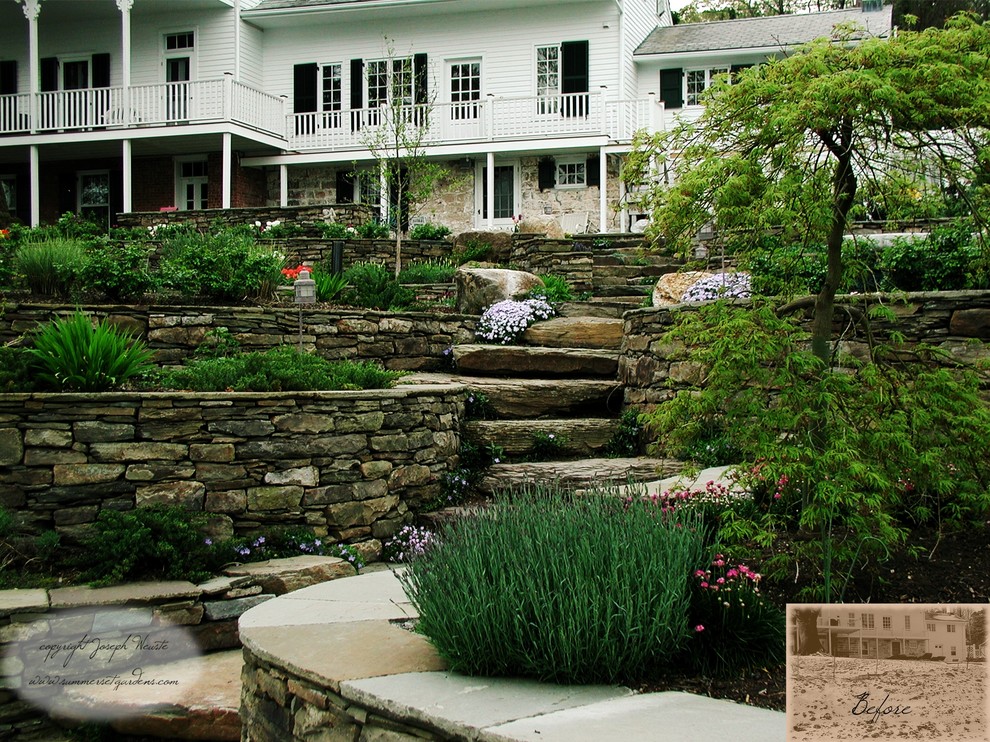 Inspiration for a mid-sized traditional partial sun backyard stone retaining wall landscape in Newark.