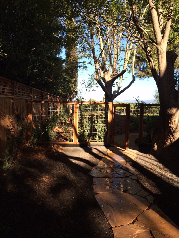 Photo of a large classic front driveway partial sun garden in San Francisco with natural stone paving.