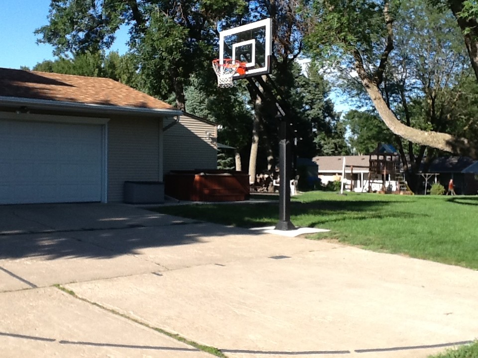 Photo of a large traditional partial sun front yard outdoor sport court in Omaha.