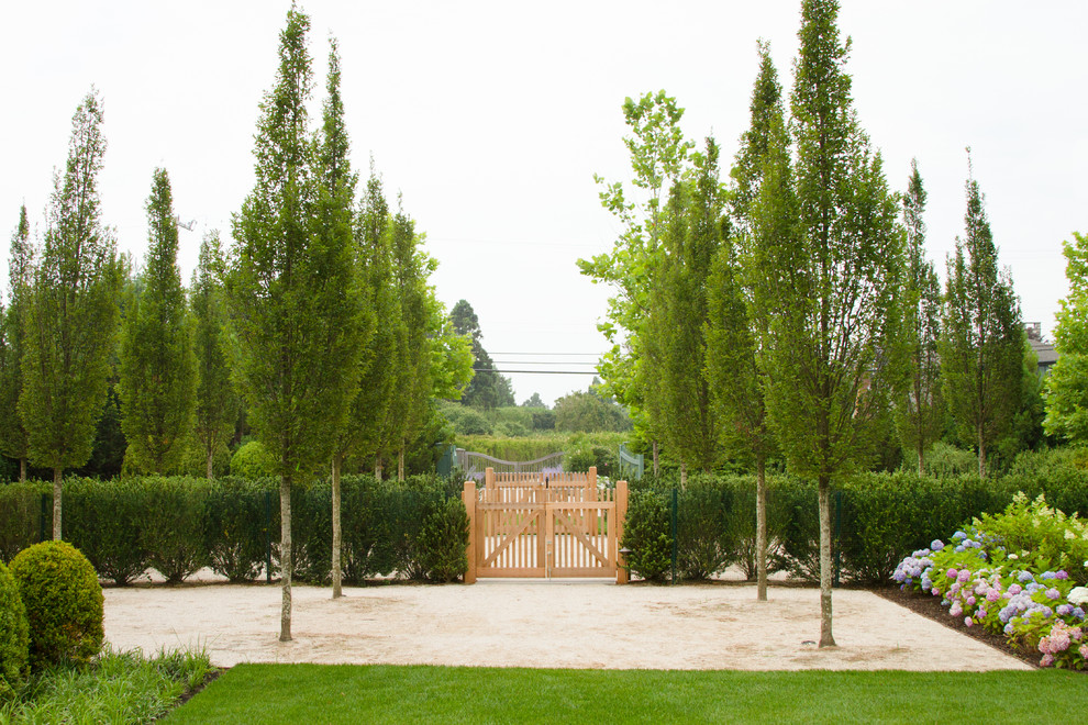 This is an example of a large contemporary full sun courtyard gravel landscaping in New York for summer.