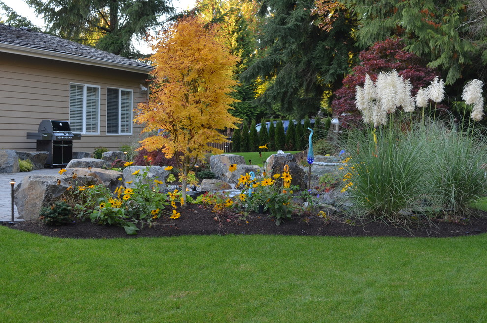 Inspiration for a large traditional backyard mulch formal garden in Seattle.