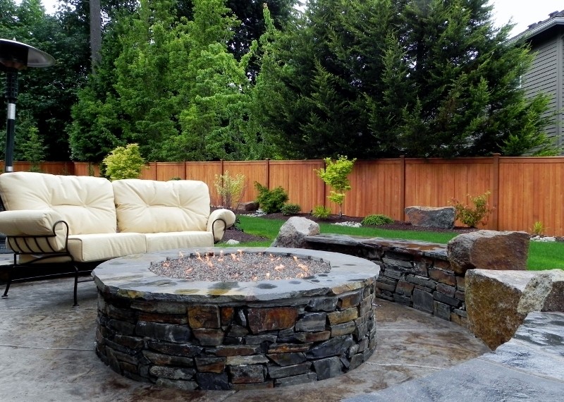 Inspiration for a medium sized eclectic back patio in Seattle with a fire feature and stamped concrete.