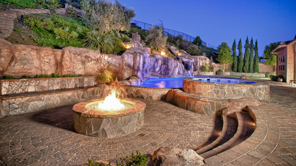 Inspiration for a huge backyard concrete paver landscaping in San Diego with a fire pit.