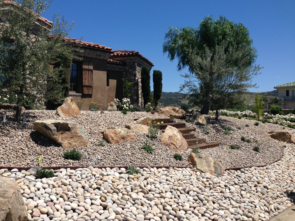 Design ideas for a drought-tolerant front yard stone landscaping in San Diego.