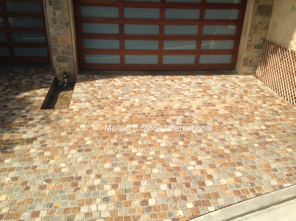 This is an example of a transitional front yard stone driveway in Orange County.