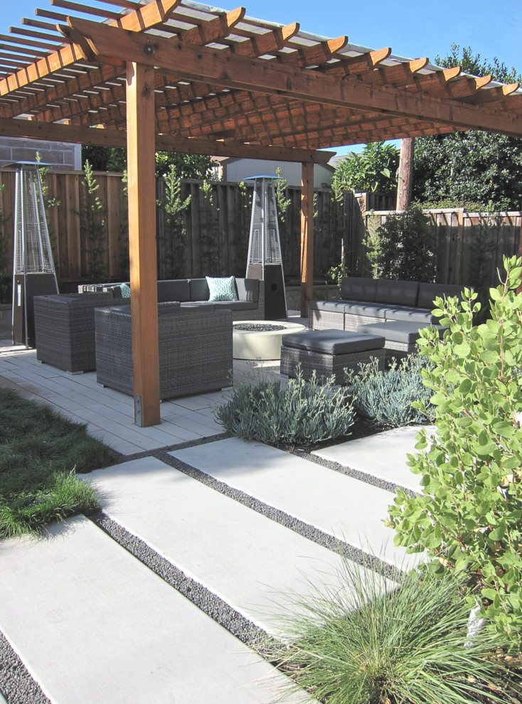 Photo of a mid-sized modern full sun backyard concrete paver landscaping in San Francisco with a fire pit.
