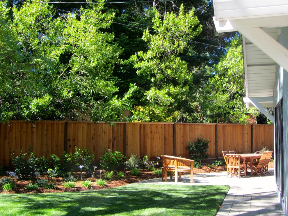 This is an example of a mid-sized transitional full sun backyard concrete paver retaining wall landscape in San Francisco.