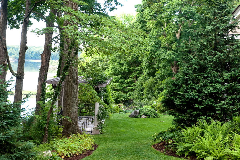 На фото: тенистый участок и сад на заднем дворе в классическом стиле с