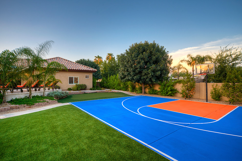This is an example of a contemporary garden fence in Phoenix with an outdoor sport court.