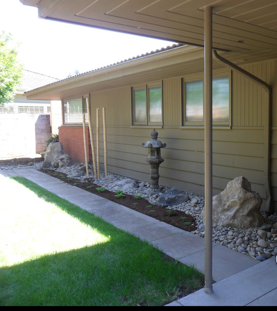 Sculpture under eaves Asian Garden Portland by Planit Earth