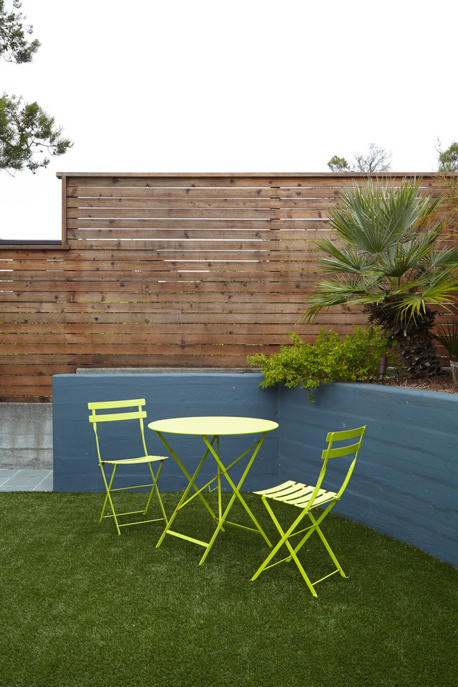 This is an example of a mid-sized contemporary full sun backyard stone landscaping in San Francisco.